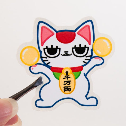 Cartoon cat sticker with a hand holding a golden ball on a white background