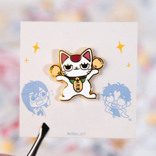Card with cartoon cat design held by a hand against a colorful blurred background