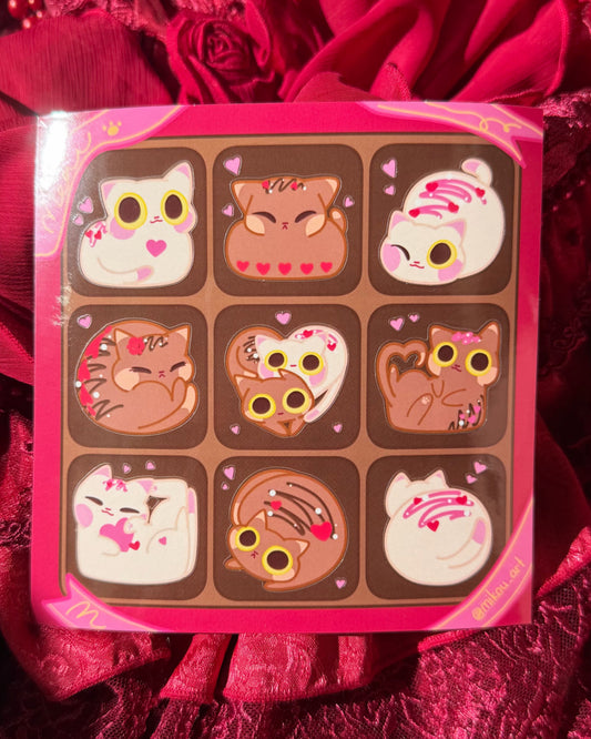 Chocolate bar set with cartoon cat designs on a red fabric background
